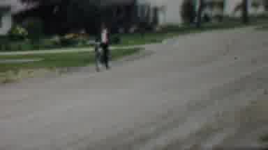 Louisiana USA (1959): A Boy Riding A Bicycle Down A Dirt Road