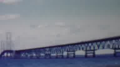 Louisiana USA (1959): Waves Crashing Against The Shore Underneath The Bridge