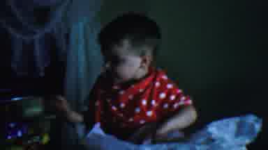 Omaha Nebraska USA (1959): Small Child Opening Presents Plays With Toy Top