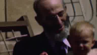 San Diego California USA (1961): An Elderly Man Holds And Talks To A Crying Baby