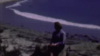 San Diego California USA (1961): A Woman Sits On A Large Rock Overlooking A Rock
