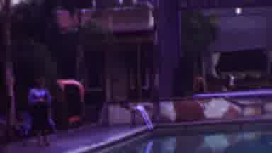 San Diego California USA (1961): Woman Walking Past A Swimming Pool After A