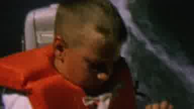 St Paul Minnesota USA (1962): Young Boy Eating While On Board Moving Boat