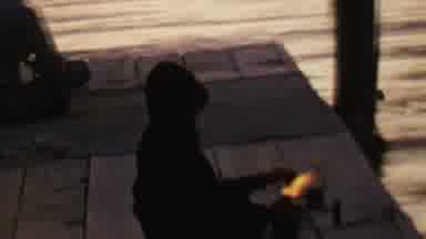 St Paul Minnesota USA (1962): Boy In Hoodie Sits On Dock Playing With Fire
