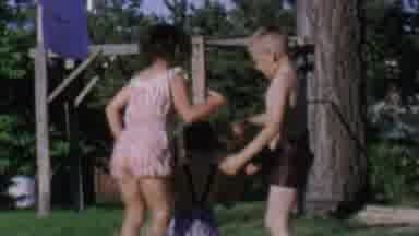 St Paul Minnesota USA (1962): Three Kids Jumping On The Ground Playing In The
