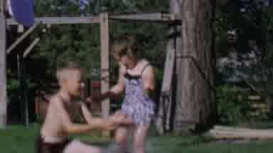 St Paul Minnesota USA (1962): Three Children Splash And Play In Water In The