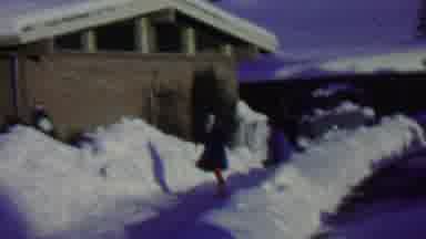 St Paul Minnesota USA (1962): Happy Child Walking In Snow In Front Of A House With