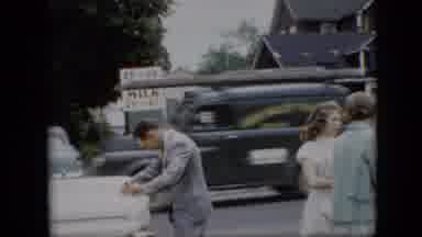 Pennsylvania (1957): Women Gathered On A Busy Street Waiting While A Man Fixes