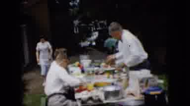 Pennsylvania (1957): Woman Walking Around Picnic Table With A Group Sharing A