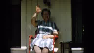 PENNSYLVANIA-1957: Elderly Woman Smiling and Waving on Porch