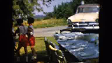 Pennsylvania (1957): Girls Standing In Front Of A Table And A Yellow Car