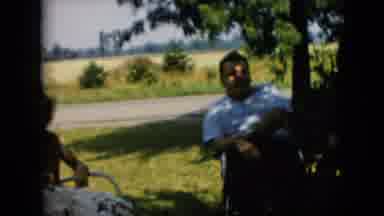 Pennsylvania (1957): People Sit In Chairs Outside Next To A Road In The Summer