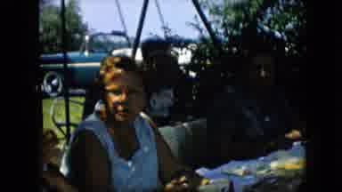 Pennsylvania (1957): People Gather Outside Around Picnic Table While Children