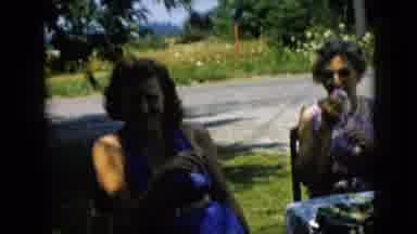 Pennsylvania (1957): Two Ladies Sitting Outside Near A Busy Street.
