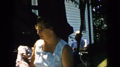 Pennsylvania (1957): A Mature Woman Throws Her Hands Up As She Works Outdoors With
