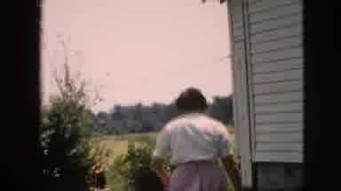 Pennsylvania (1957): Woman Walking Around Side Of House To Backyard And Men