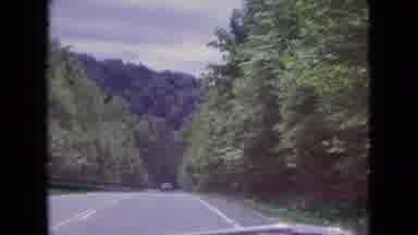 Niagra Falls New York (1964): Driving Along A Tree Lined Road With Hills And