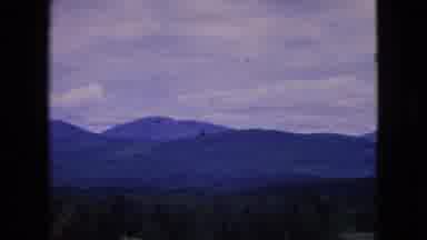 Niagra Falls New York (1964): Conifer Covered Low Mountain Range With Fields
