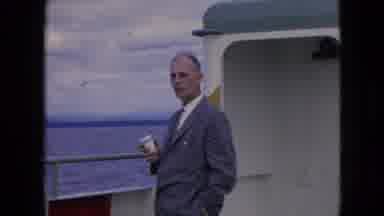 Niagra Falls New York (1964): A Man In A Suit Stands On The Back Of A Moving