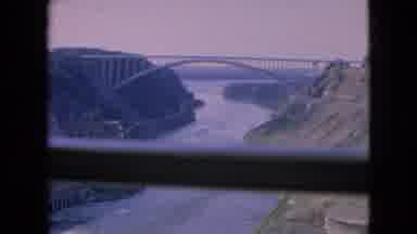 Niagra Falls New York (1964): A River Flowing Under A Large Bridge