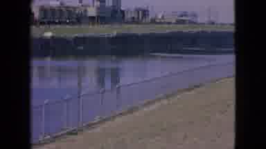 Niagra Falls New York (1964): Polluted Smoke River Near Dark Looming Grey City.