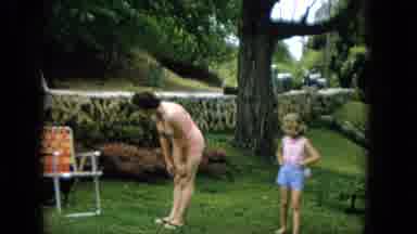 Hawaii (1965): Woman And Child Playing In Yard With Puppy
