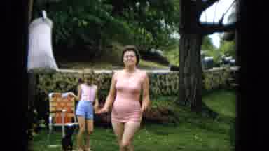 Hawaii (1965): Woman Posing With Child Playing In Background