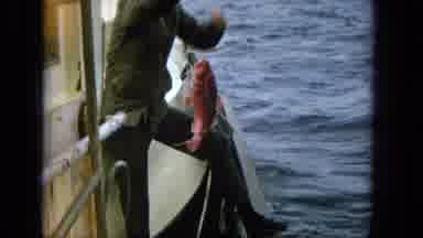 1965:EASTER MOLOKAI WHALES BEACH PARADE ALOHA TOWER. Man On A Boat Catching A