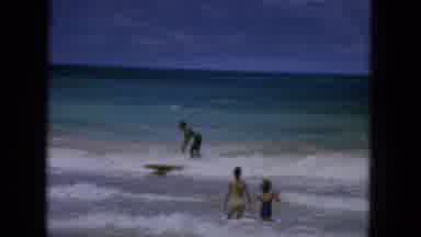 1965:EASTER MOLOKAI WHALES BEACH PARADE ALOHA TOWER. People At A Beach Surfing,