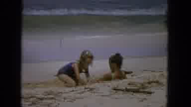 1965: Girls Playfully Burying Each Other on Beach in Vintage Super 8 Footage