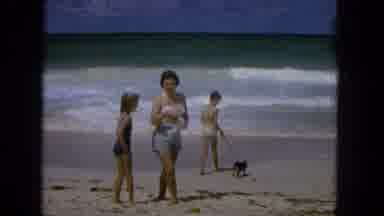 1965:EASTER MOLOKAI WHALES BEACH PARADE ALOHA TOWER. An Adult Plays At The Beach