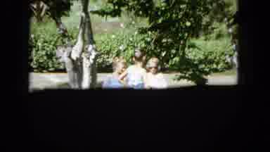 1965: Two Girls Posing Barefoot in Suburban Yard