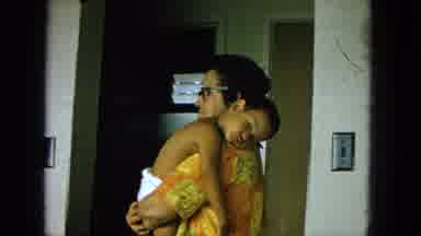 1965:EASTER MOLOKAI WHALES BEACH PARADE ALOHA TOWER. Man Happily Holds Sleeping