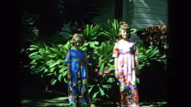 1965:EASTER MOLOKAI WHALES BEACH PARADE ALOHA TOWER. Two Young Girls In Colorful