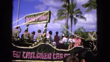 1965:EASTER MOLOKAI WHALES BEACH PARADE ALOHA TOWER. People Riding On A Parade