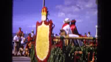 1965: Easter Parade On Molokai Beach With Floral Floats, Horse Rider, And Spectators