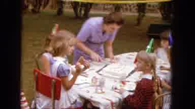 1965: Children Sitting Around A Birthday Party Table With Cake And Party Hats