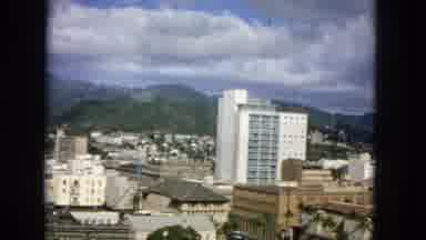 1965:EASTER MOLOKAI WHALES BEACH PARADE ALOHA TOWER. A Mountain Sitting Behind A