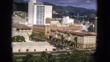 1965:EASTER MOLOKAI WHALES BEACH PARADE ALOHA TOWER. Cars Riding Through City