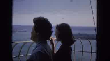 1965:EASTER MOLOKAI WHALES BEACH PARADE ALOHA TOWER. People Touring React To