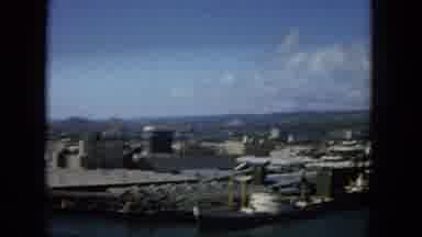 1965:EASTER MOLOKAI WHALES BEACH PARADE ALOHA TOWER. A View Of A City Skyline