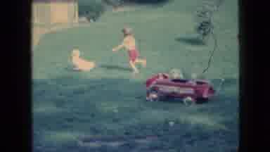Wellsburg Iowa (1965): Young Child Chases A White Duck Through Their Backyard