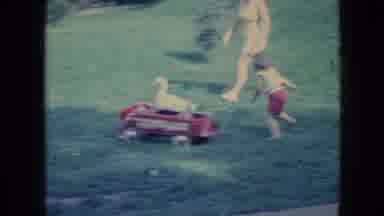 Wellsburg Iowa (1965): Mother And Son Chasing A Duck