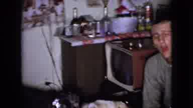 Wellsburg Iowa (1965): Room Of People With Two Dogs Entertain For The Camera