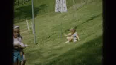 Wellsburg Iowa (1965): Three Kids Playing Outside And One Of Them Walks Up The