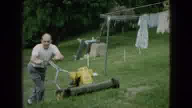 Wellsburg Iowa (1965): Man Mowing Lawn In Backyard