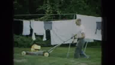 Wellsburg Iowa (1965): Man Mowing The Lawn In Front Of Clean Laundry