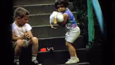 Wellsburg Iowa (1965): Young Girl Lifts Duck Off A Concrete Stairwell, Away From