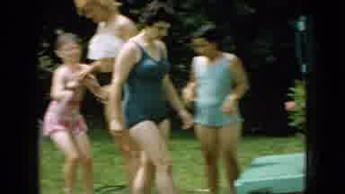 Wellsburg Iowa (1965): Several Girls In Swimsuits Cooling Off With Hose In Yard