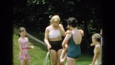 Wellsburg Iowa (1965): Women And Girls Dressed In Swimming Suits Play With Water
